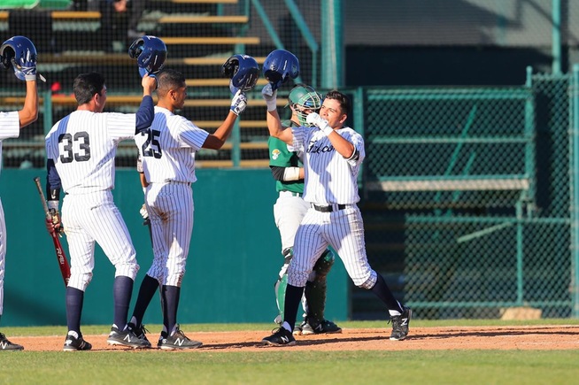 Jesus Mercado is greeted at home plate after his two-run home run
