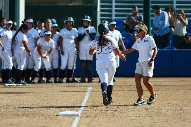 Crystal Cano (32) rounds third base after the first of her two 2-run home runs