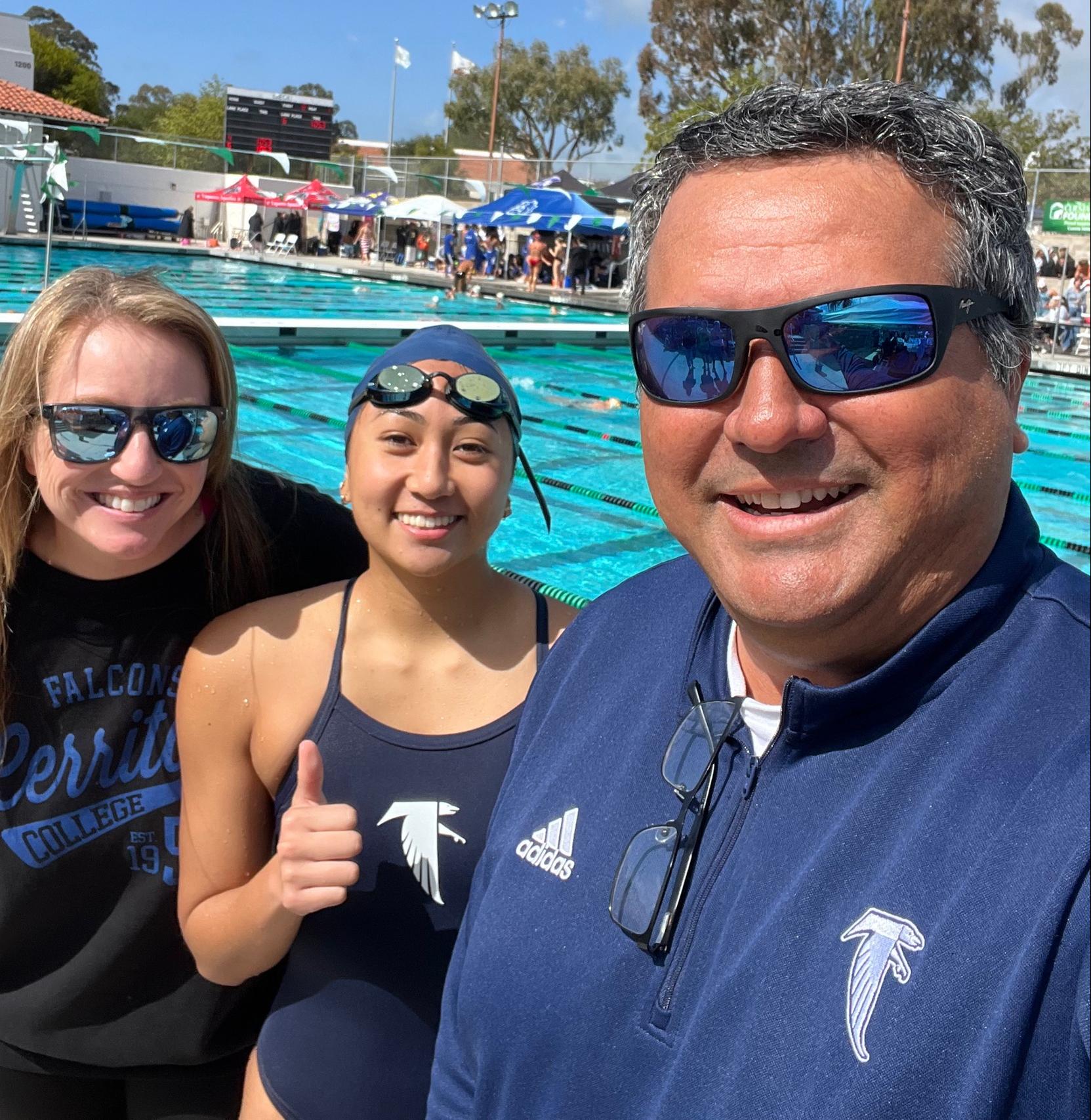 Sydney Romero is flanked by coaches Denise Peasley and Sergio Macias after setting a new school record in the 200-yard backstroke