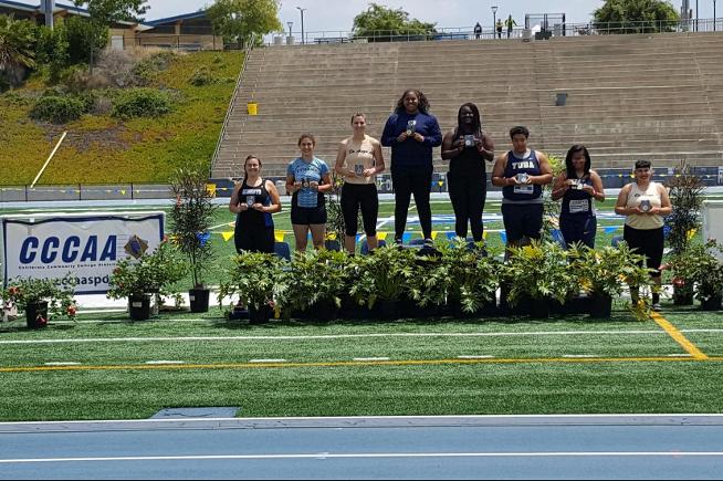 Destiny Talalemotu accepts her state championship medal for the hammer